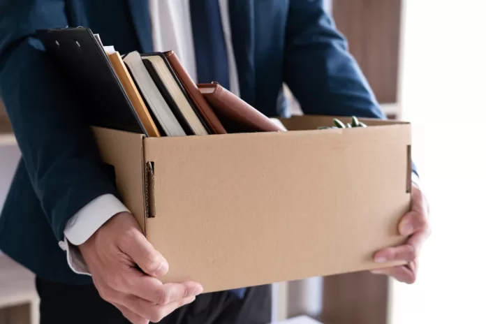businessmen are holding resignation document packing personal company brown cardboard box changing work resign concept
